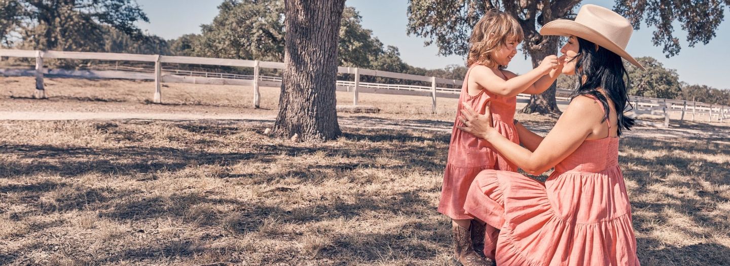 Mom and daughter wearing matching pink dresses