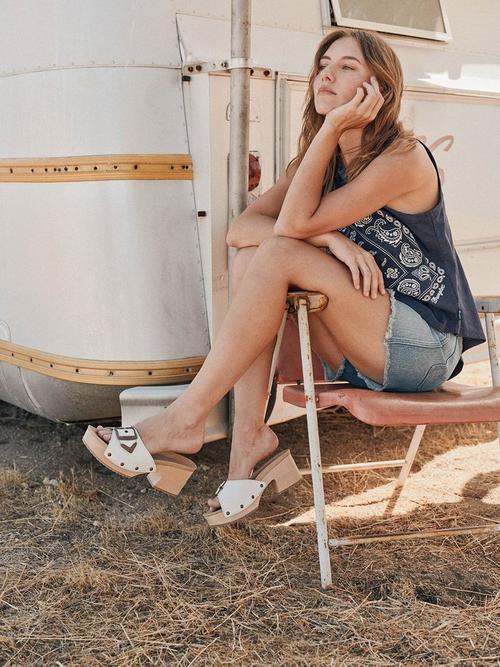 Girl sitting wearing a bandanna tank and sandals