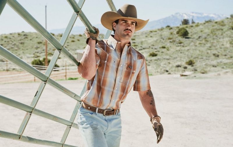 Guy carrying a cattle fence.