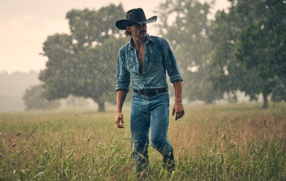 Tucker Wetmore standing in a dark, rainy field