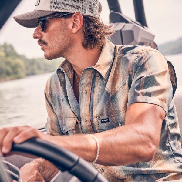 Tucker wetmore driving a boat, wearing ATG - shop now