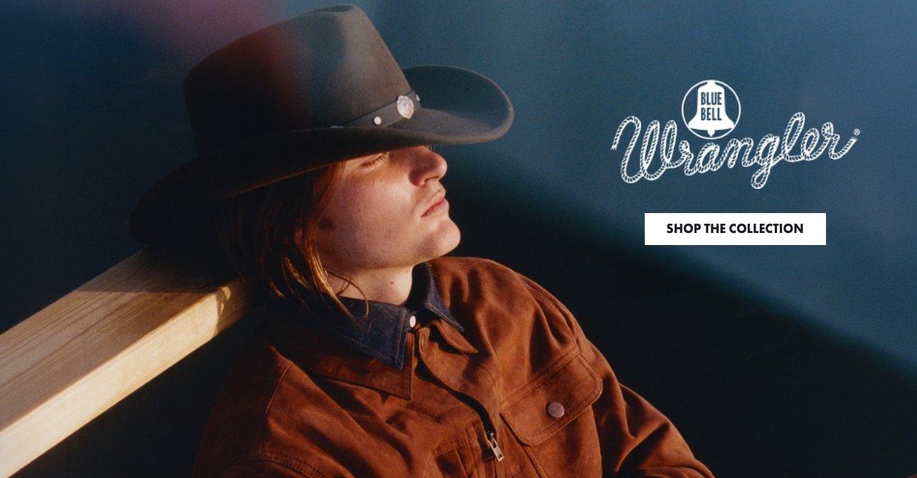 man sitting looking into the distance wearing Wrangler Blue Bell - Shop Wrangler Blue Bell