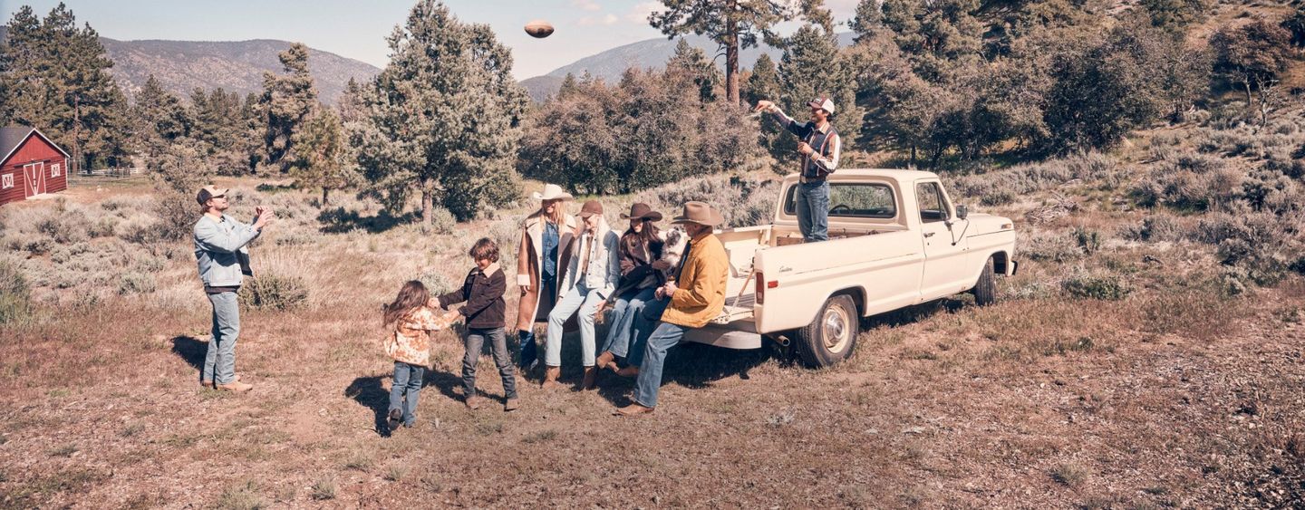 Group of a bunch of people hanging out on the edge of the woods
