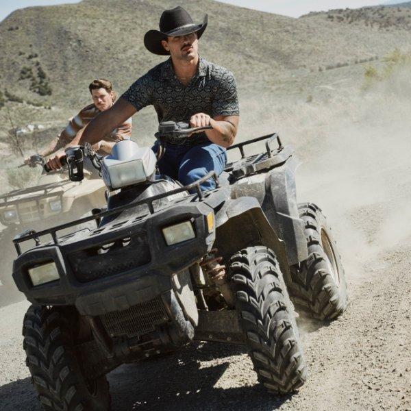 a man on a fourwheeler wearing Wrangler outdoor apparel and a cowboy hat