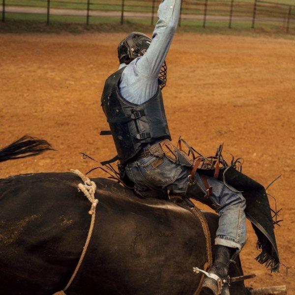 man riding a bull wearing Wrangler Toughlite jeans