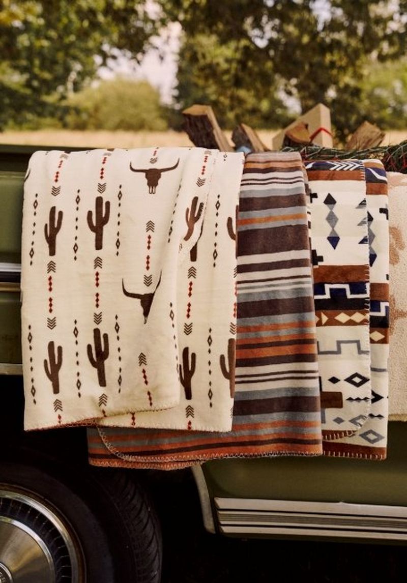 Blankets draped over the side of a vintage truck - shop gifts for the home