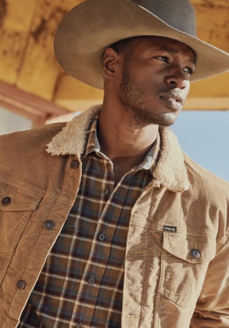 Close up shot of a guy wearing khaki sherpha jacket and cowboy hat - shop sherpa