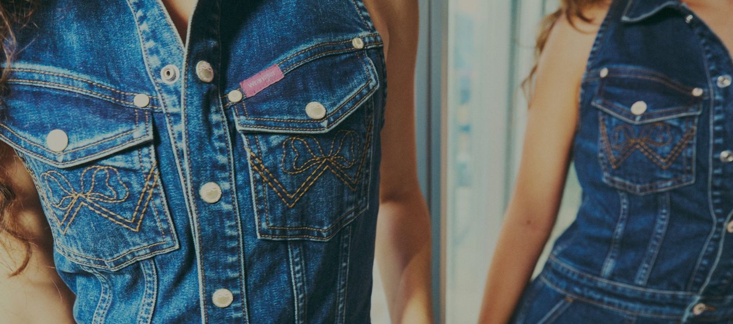 Up close shot of wrangler x loveshackfancy denim vest - sign up to be notified of the drop