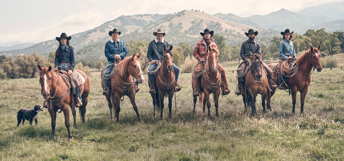 A group of cowboys on horseback with a hunting dog. Shop Fall