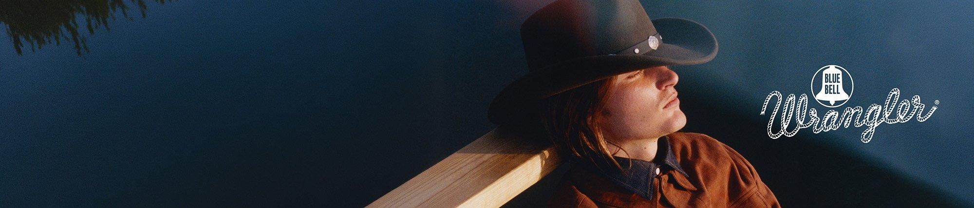 Up close shot of a guy wearing a cowboy hat and bluebell denim