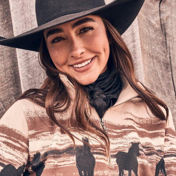 close up shot of woman in Wrangler fleece jacket and cowboy hat.