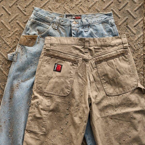 close up shot of two dirty workwear pants