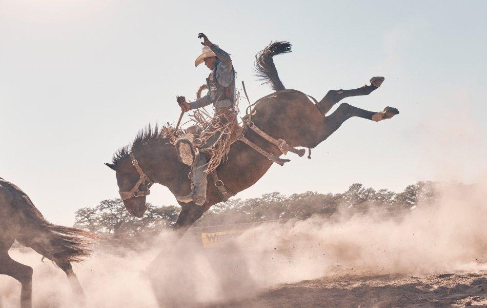 man on bucking bronco wearing wrangler product