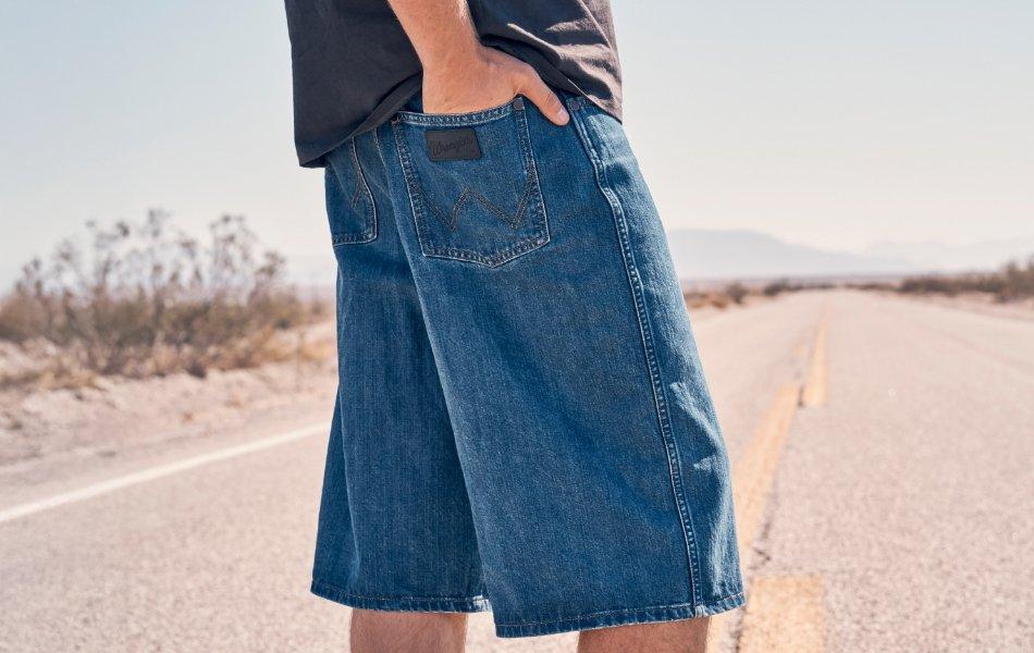 wrangler patch shot on denim shorts with a hand in the back pocket