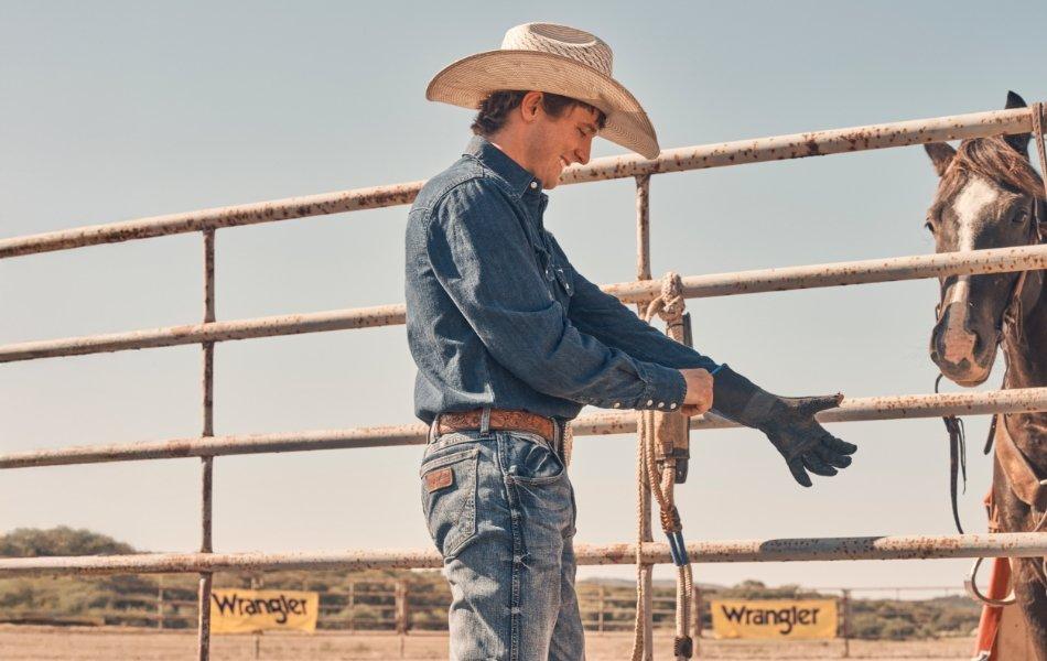 Stetson Wright putting on rodeo gear before riding.