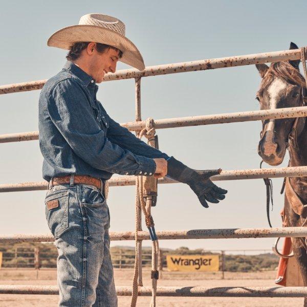 Stetson Wright putting on rodeo gear before riding