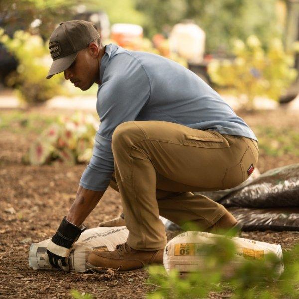 man kneeling in Wrangler workwear