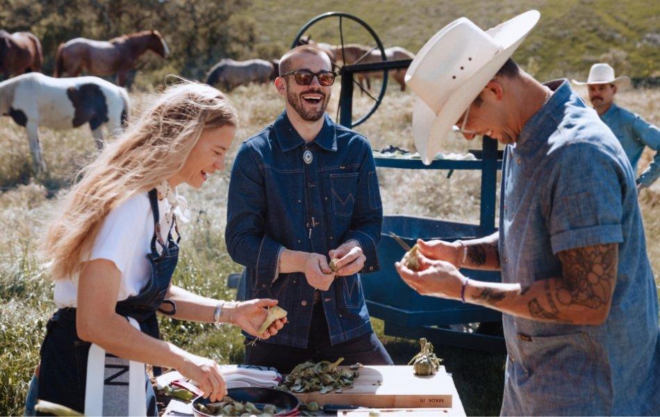 three people prepping food wearing Wrangler x Made In apparel