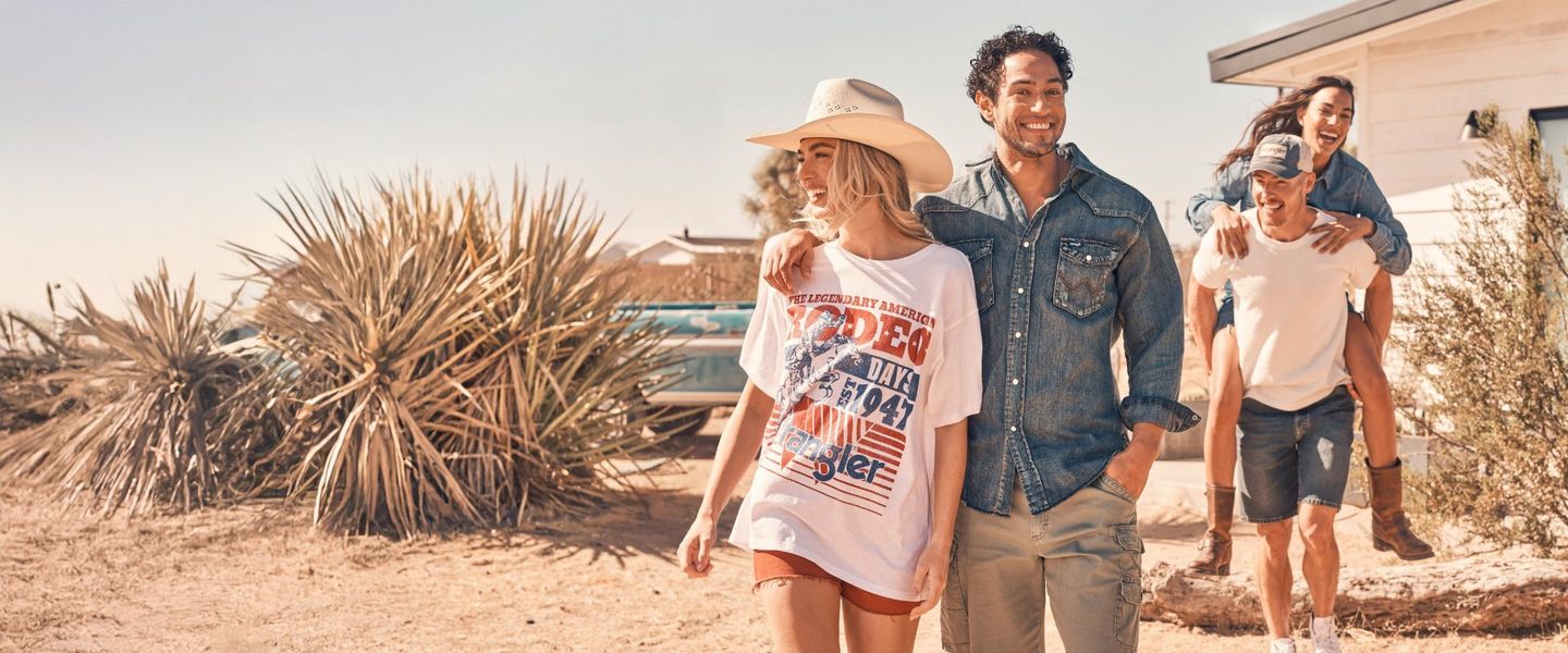 group of four friends walking towards the camera wearing Wrangler apparel.