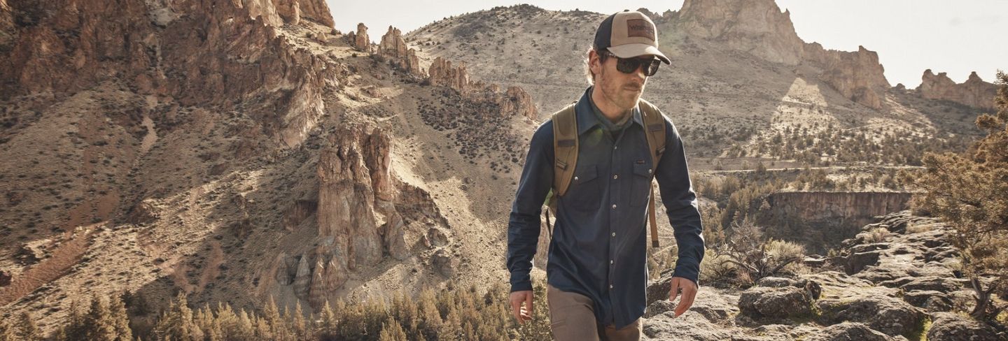 man hiking wearing Wrangler Outdoor