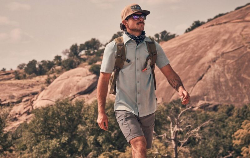 Guy backpacking through the highlands wearing shorts - Shop The Harbor Short