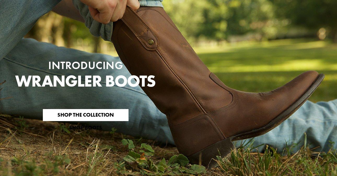 man pulling on brown leather boot - Shop Wrangler Footwear Collection