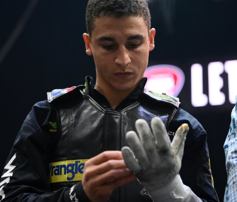 Dalton Kasel in the arena, looking at his gloves