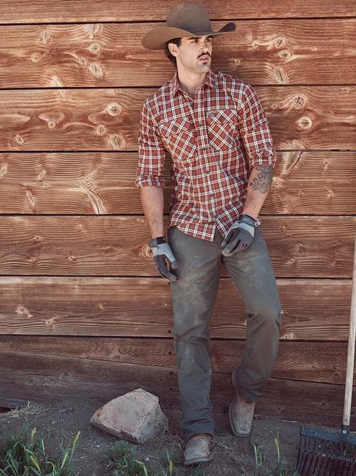 Photo of a man in a hard hat wearing Wrangler workwear bottoms