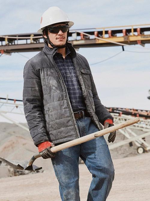 Photo of a man in a hard hat wearing Wrangler workwear jacket